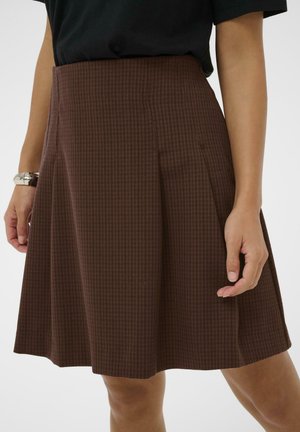 Jupe à carreaux marron avec un design plissé, fabriquée en tissu texturé. L'ourlet tombe au-dessus du genou, avec des poches latérales et une taille ajustée.