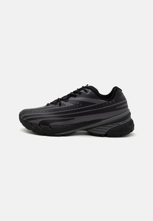 Black running shoe with a textured upper featuring gray stripes. Thick sole for cushioning, round toe, and flat laces for secure fit.