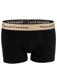 Boxers noirs avec une taille élastique beige sur laquelle est imprimé "Vincent Creation" en noir. Texture lisse et design ajusté.
