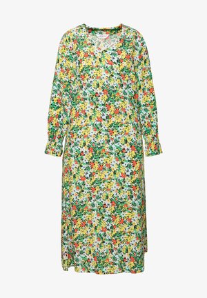 Kukallinen mekko, jossa on V-mallinen kaula-aukko ja pitkät hihat. Kangas sisältää kirkkaan keltaisia, punaisia, sinisiä ja vihreitä kukkia lehtimäisellä taustalla.