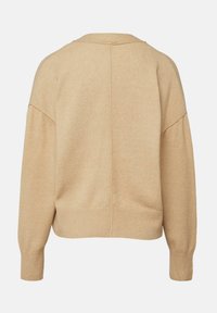 Pull beige à manches longues avec un ourlet et des poignets côtelés, présentant une couture au centre du dos et une coupe décontractée.