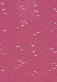 Pink fabric with a textured finish, featuring scattered small white bird motifs across the surface.