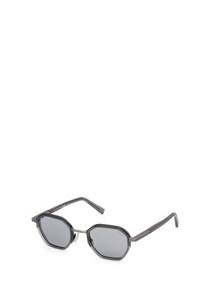 Sunglasses with octagonal gray lenses, dark gray plastic frame, thin temples, and silver accents near the hinges.
