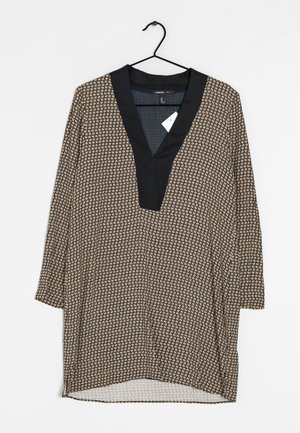 Túnica de manga larga con cuello azul marino y cuerpo estampado en beige y negro. Presenta un escote en V y aberturas laterales en el dobladillo.