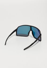 Schwarze Sonnenbrille mit großen, quadratischen Gläsern und einem blauen Verlaufsfarbton. Schlanke, gerade Bügel mit einem goldenen Akzent. Glatte, matte Oberfläche.