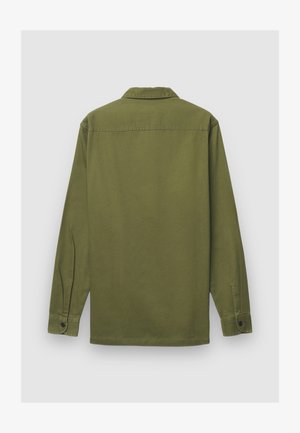 Chemise verte à manches longues avec col, texture unie et poignets à boutons. Présente une coupe droite et un empiècement au dos.