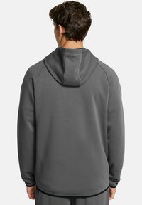 Gray hooded sweatshirt with a soft texture, raglan sleeves, and a round hem. Features a close-fitting hood. No visible logos or patterns.