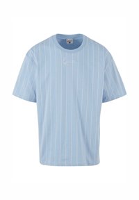 Light blue short-sleeve t-shirt with vertical white stripes and a rounded neckline. Features a small signature graphic on the chest.