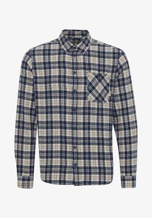 Srajca iz flanel materiala z gumbki, z mornarsko modrim in kremnim karirastim vzorcem, ki ima koničast ovratnik in en sam žep na prsih.