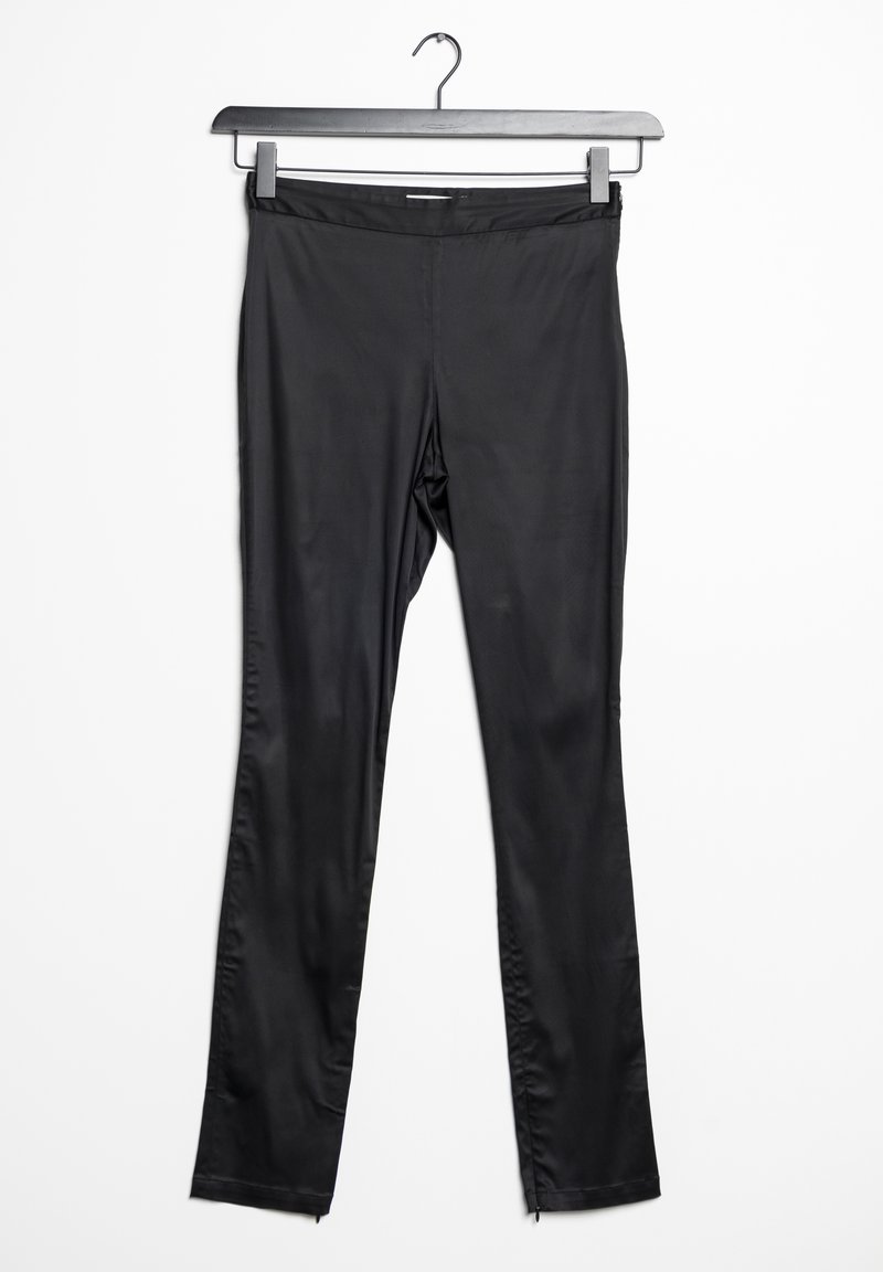 Leggings noirs en matériau lisse et extensible, dotés d'un design ajusté, de longues jambes et de fermetures éclair aux ourlets des chevilles.