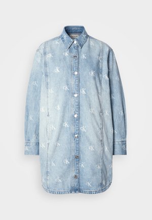 Denim shirt dress in light blue with a subtly distressed finish, featuring a button closure, collar, and repeated logo pattern.