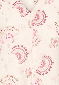 Floral patterned fabric featuring pink and beige swirls on a light cream background, with a soft texture and a V-neck design.