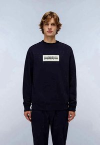 Sweatshirt da Marinha feito de uma mistura de algodão, com punhos e barra canelados, e um logo retangular branco na parte da frente. Design de ajuste casual.