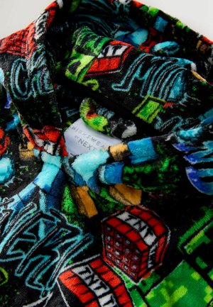 Fleece nightwear top featuring a black background with colorful graphics and patterns, including buildings and text elements. Label visible.