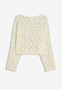 Crochet top, cream color, loose fit with long sleeves, featuring diamond patterns and a scalloped hem. Lightweight, textured knit fabric.