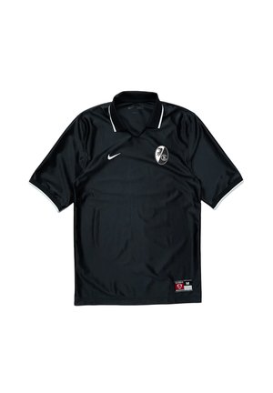 Sort Nike kortærmet sportstrøje med hvide kanter, klubmærke på venstre bryst og størrelsesmærkat nederst til højre.