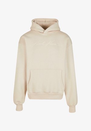 Beige hooded sweatshirt made of soft fabric. Features a front kangaroo pocket and embroidered "Karl Kami" logo in white on the chest.