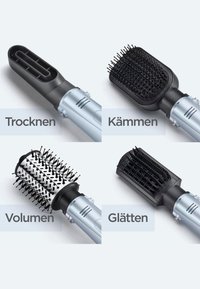 Four detachable hair styling brush heads with German labels indicating functions: drying, combing, volumizing, and smoothing.