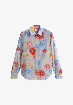 Camicia a maniche lunghe con bottoni e collo, caratterizzata da grandi motivi floreali rossi, blu, gialli e rosa su uno sfondo chiaro.