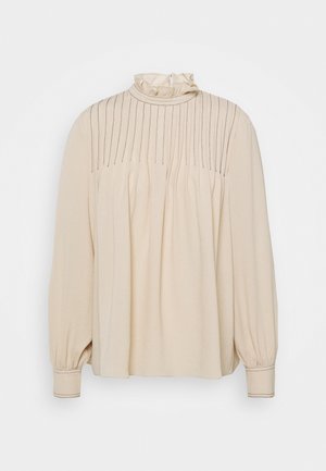 Beige blouse met lange mouwen, een gerimpelde hoge kraag, verticale plooidetails en ingezette zijkanten. Stevige textuur en aansluitende manchetten.