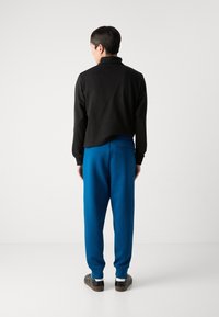 BOSS HADIKO - Spodnji deli trenirk - open blue