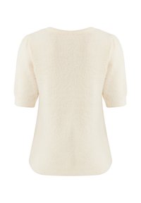 Haut à manches courtes couleur crème avec une finition douce et texturée et une coupe décontractée. Col rond simple, sans fermetures ni motifs visibles.