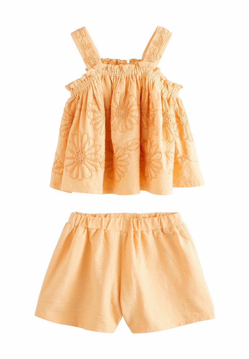 Orangenes Zweiteiler-Outfit mit einem ärmellosen Top mit floraler Stickerei und Shorts mit elastischem Bund. Strukturierter Stoff mit weicher Haptik.