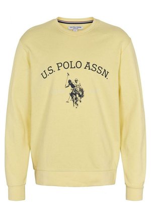 Hellgelbes Sweatshirt mit Rundhalsausschnitt, mit dem Text U.S. Polo Assn. und einer Grafik von zwei Polospielern auf Pferden in Schwarz.