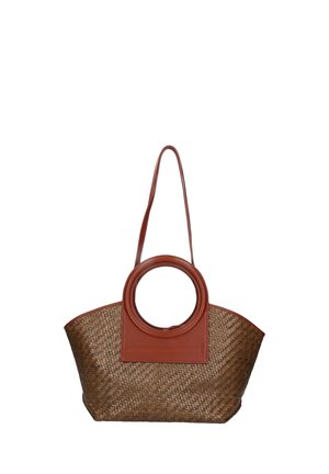 Woven straw tote bag with a brown leather circular handle and rectangular base, featuring a solid leather accent on one side.