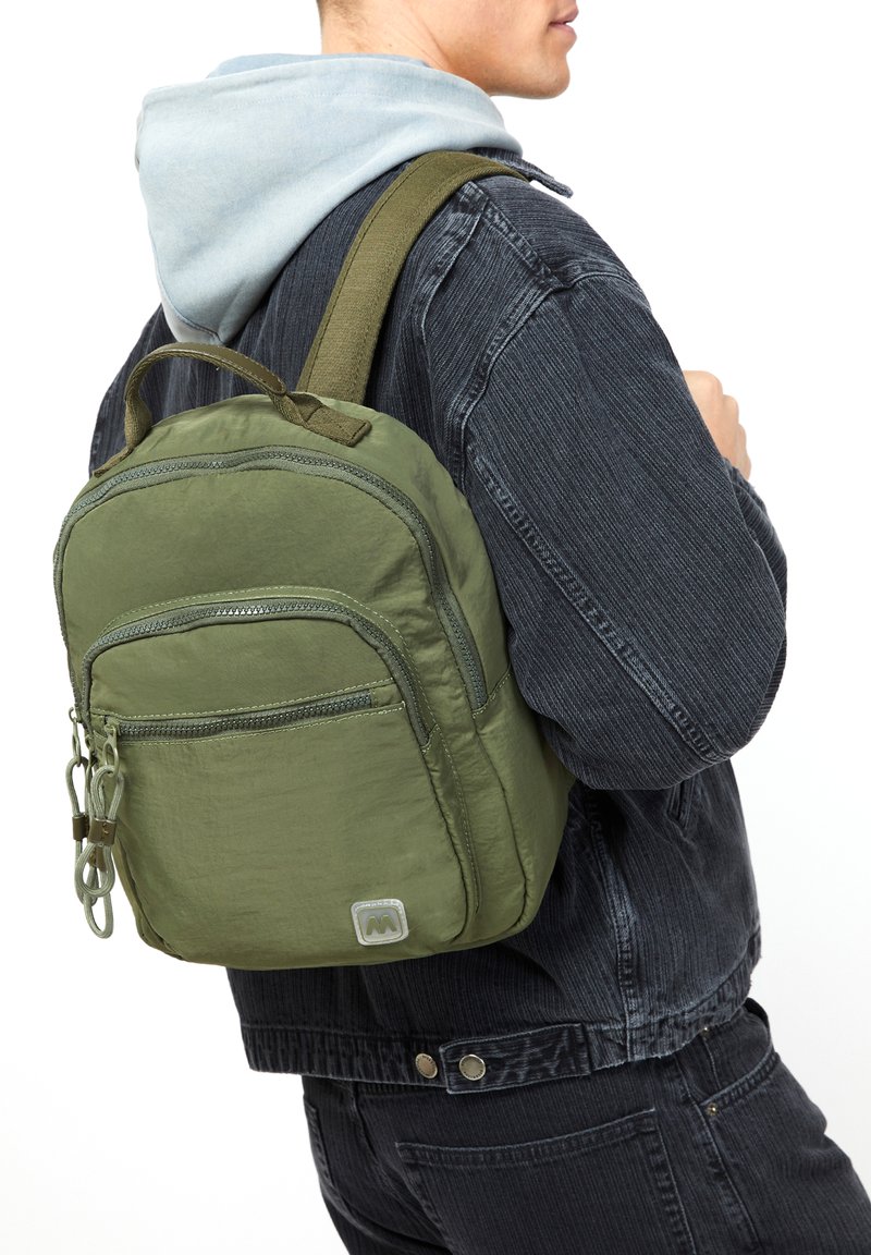 Maslinasto zelena ruksak s teksturiranim materijalom, više zip zatvarača, i remenom od mrežice. Mali logo prikazan sprijeda.