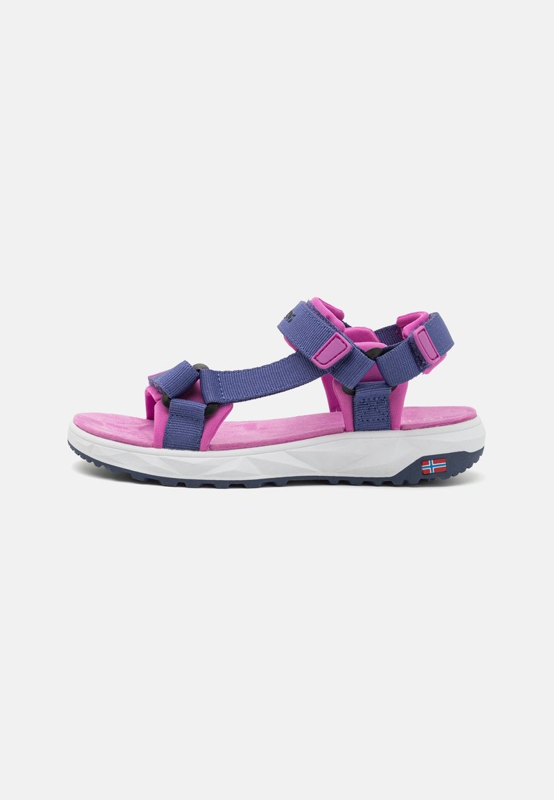 Outdoor sandal with purple straps, pink cushioning, white sole, and a small Norwegian flag on the side near the heel.