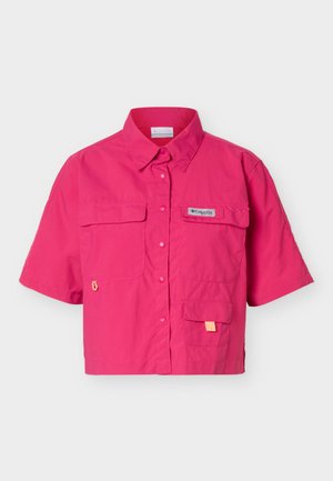 Bright pink short-sleeve button-up shirt with collar, three front pockets, and a small logo patch on the upper left pocket.