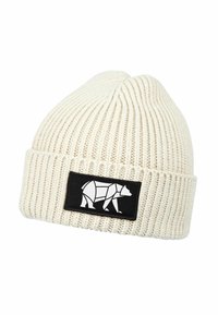 Cream-colored ribbed knit beanie with a folded cuff featuring a black patch displaying a white geometric bear design.
