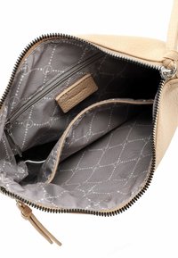 Beige leather handbag with zip closure. Interior features gray fabric lining with a geometric pattern, one zippered pocket, and two compartments.