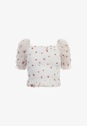Bílá blůza s balónovými rukávy a nařaseným živůtkem, zdobená červenými srdíčky a tečkovanou strukturou. Krátké, volánkové rukávy zlepšují design.