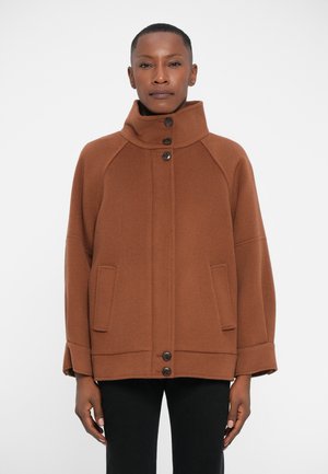 Brown wool blend coat with a high collar, button closure, two front pockets, and a relaxed fit, featuring raglan sleeves and stitched detailing.
