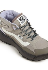 Gray and beige athletic shoe with patterned fabric, white swoosh design, thick sole, and black laces. Features padded collar and logo tag.