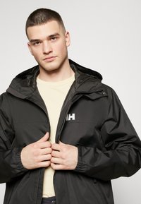 Helly Hansen ERVIK - Regenjas - black