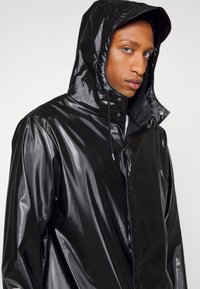 Rains LONG JACKET UNISEX - Parca - shinny black
