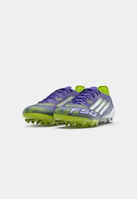 Pair of purple and neon green Adidas F50 soccer cleats with white stripes and studs, angled front view on white background.