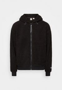 Schwarze Fleece-Hoodie mit vollem Reißverschluss, Kordelzugkapuze und gerippten Bündchen und Saum, entworfen für Wärme und lässigen Tragekomfort.