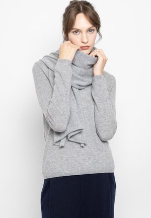 Gray knitted sweater with high collar and layered scarf detail, soft texture, long sleeves, and fitted style.