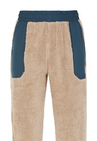 Pantalones de forro polar beige con acentos de nylon azul a los lados, con una cintura elástica y una superficie blanda y texturizada.