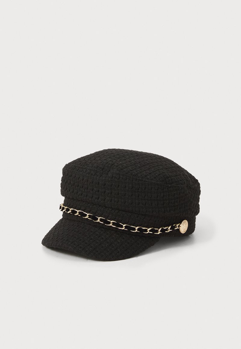 Black textured cap with a flat brim, featuring a gold chain accent around the base and a decorative button on the side.