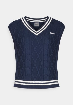 Tamsiai mėlynas megztas rankovių neturintis megztinis su V formos iškirpte, su kabelių raštu, baltomis juostelėmis ant apykaklės ir apatinės dalies, ir "Guess" logotipu.