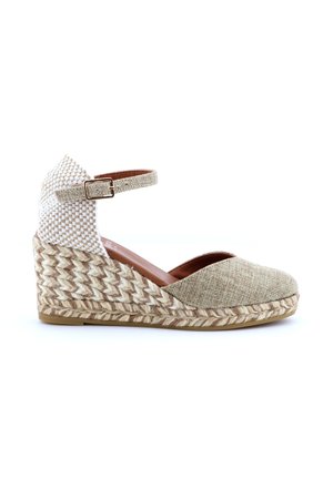 Scarpa espadrillas con zeppa beige con tacco intrecciato, fibbia alla caviglia e punta chiusa e arrotondata.