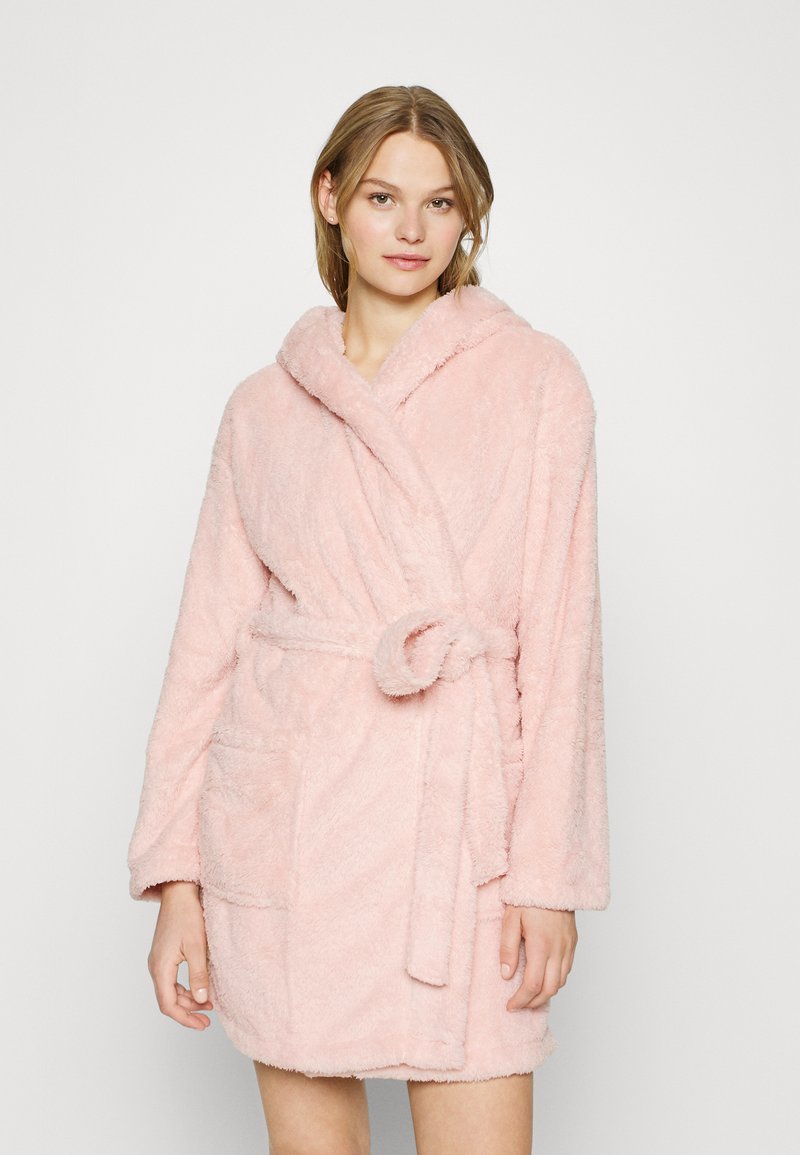 Pink, fluffy bathrobe with a hood, tied belt, and two front pockets; made of soft, textured fabric for comfort and warmth.