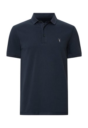 Marinblå polo tröja i bomull, med en treknappsknäppning, korta ärmar och ett litet emblem på vänstra bröstet.