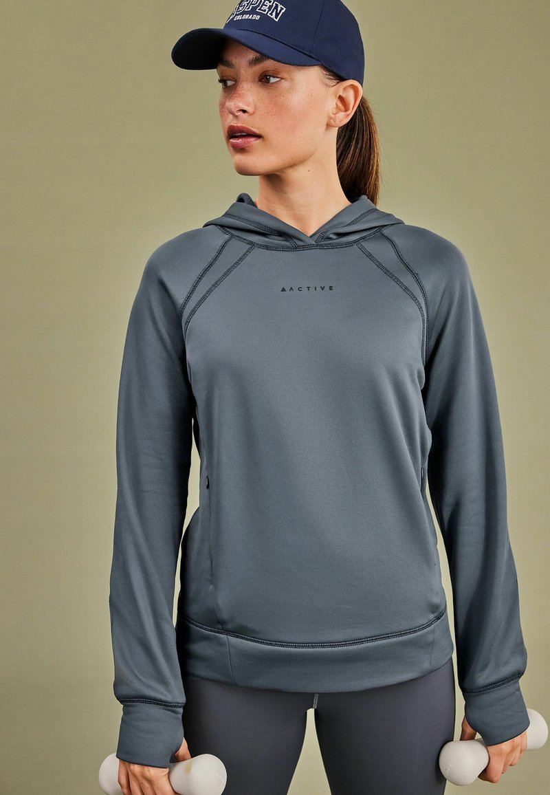Hallukas halli kapuutsiga sweatshirt, mis on valmistatud siledast kangast, rinnal logoga, küljetaskudega ja varrukates pöidlaugudega.