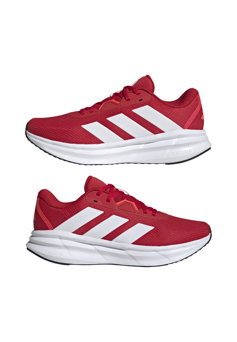 Zapatillas deportivas rojas con parte superior de malla, rayas blancas y suela de goma negra. Cuentan con un collar acolchado y una amortiguación CLOUDFOAM.